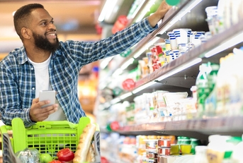 black male shopping groceries in supermarket