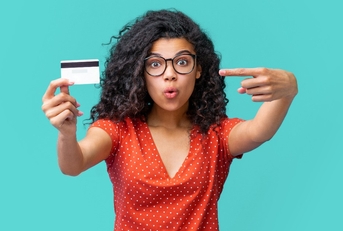 young african american woman in trendy spectacles smiling and holding credit card 