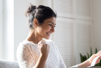 Happy woman reading letter