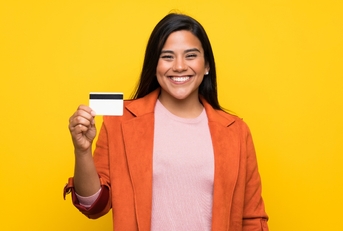 Young woman holding a credit card