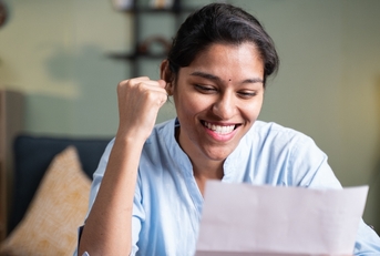 Happy woman reading letter