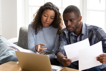 African American couple discussing about paper documents