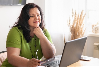 woman in the office sitting at a desk with a laptop