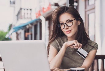 Woman on computer with credit card