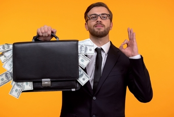 man wearing glasses and holding a money bag