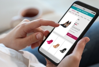 Woman shopping online via smartphone indoors