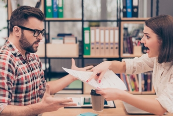 Young frustrated woman yelling and screaming on her colleague