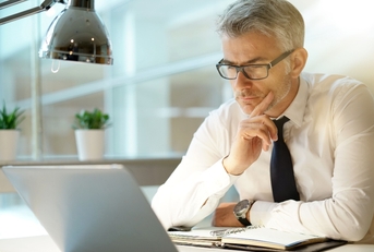 Businessman working on laptop in office