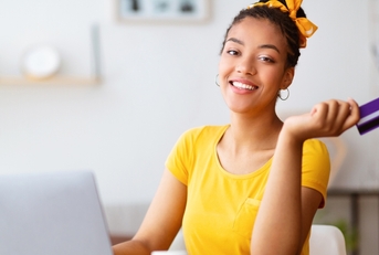 Smiling woman using credit card