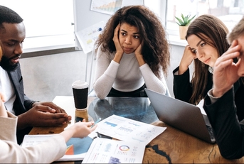 Tired business team are having a briefing meeting