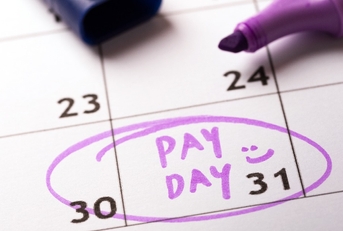 payday concept calendar with marker and circled day of salary