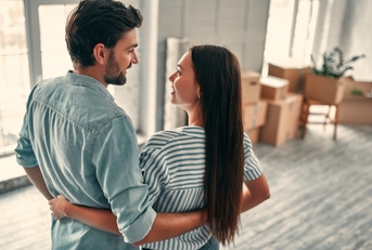 Couple looking at each other in new home
