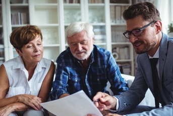 Senior couple planning their investments with financial advisor