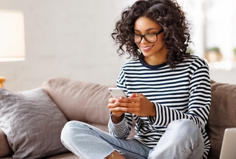 Woman smiling and looking at phone