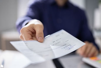 businessperson hands giving cheque