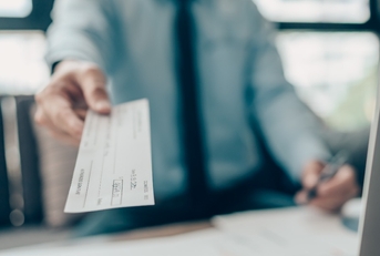  hand giving cheque to customer