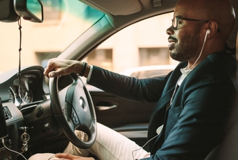 Man driving with headphones in