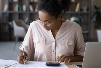woman sitting at desk managing budget 