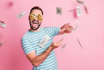 man with dollar-sign glasses throwing money