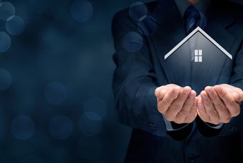 man in a black suit holding a virtual home