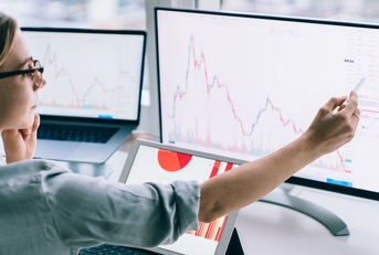 professional woman working with graphs on computer