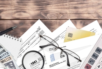 Estate tax forms and papers scattered on a desk 