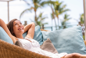 woman enjoying sofa furniture of outdoor patio