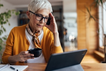 senior lady in stress looking at laptop
