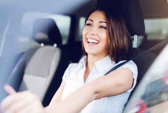 happy woman driving her car