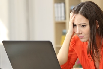 frustrated young woman using a laptop