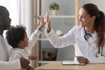 doctor, child, and father during a doctor visit