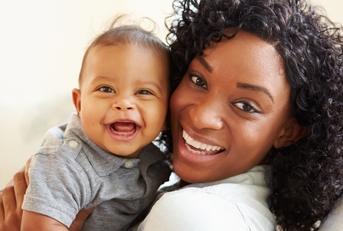 Mother holding happy baby