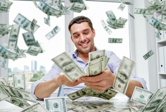 happy businessman with heap of money