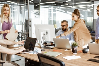 different employees working and interacting in workspace 