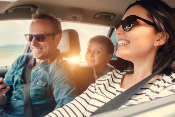 A happy family driving in a car
