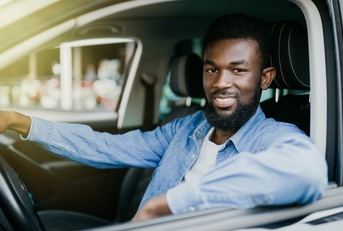 Smiling man driving a car