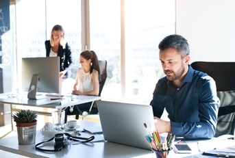 three businesspeople in the office working together