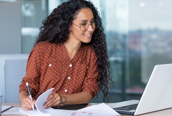 businesswoman working inside office with documents and laptop