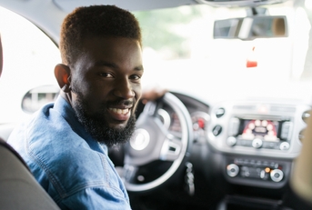 Smiling man driving a car