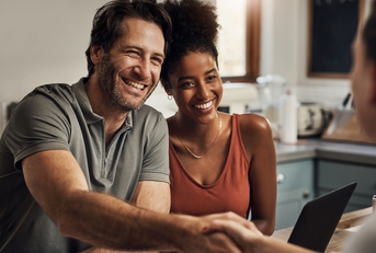 middle aged man shaking hands with a financial advisor