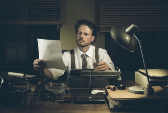 A person in old times reviewing a document