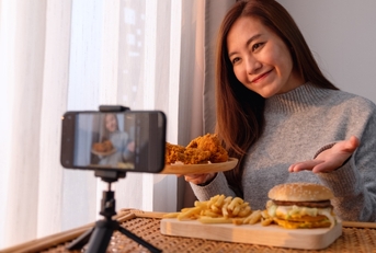 Woman filing  herself with food