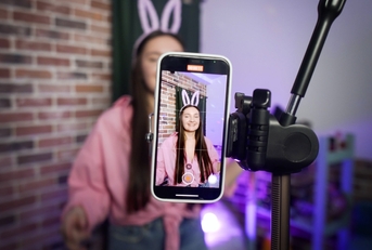 TikTok creator talking in front of a camera phone