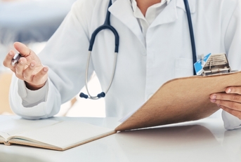 doctor talking about health insurance at clinic