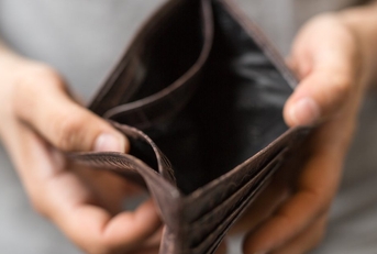 Hands holding an empty wallet.