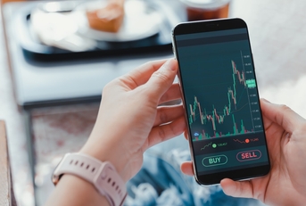 woman checking stocks on smartphone