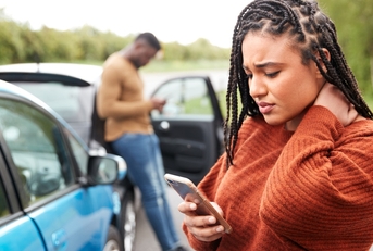 Woman holding neck after an accident