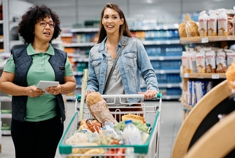 woman talks to supermarket worker adobe