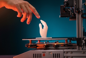 A human hand touching a 3D-printed hand