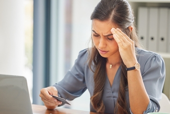 Stressed woman looking at credit card